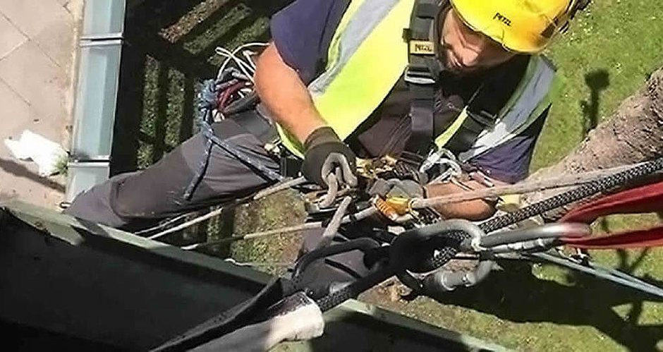Rope access technician using professional rope systems and safety equipment