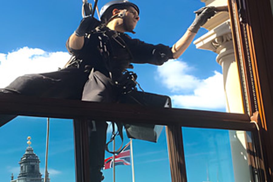 Technician carrying out brickwork repairs using rope access