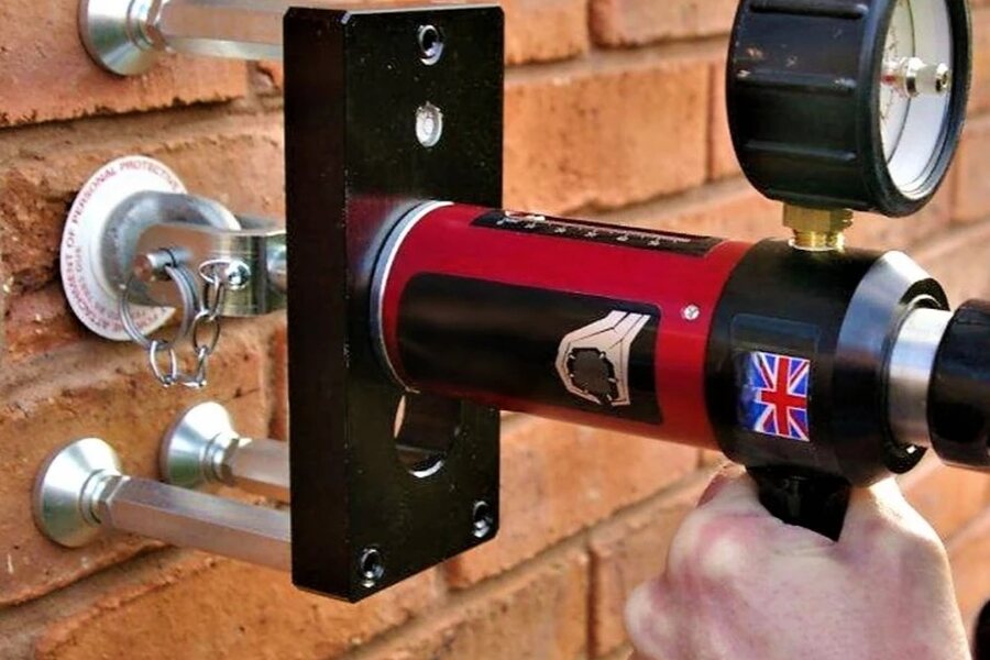 Eyebolt testing equipment attached to anchors in brickwork