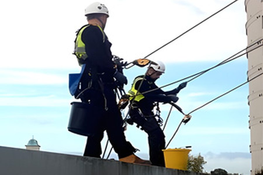 Rope-access technicians carrying out commercial building repairs
