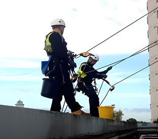 Rope access experts conducting maintenance and repairs on various structures, ensuring safety and quality in their workmanship.